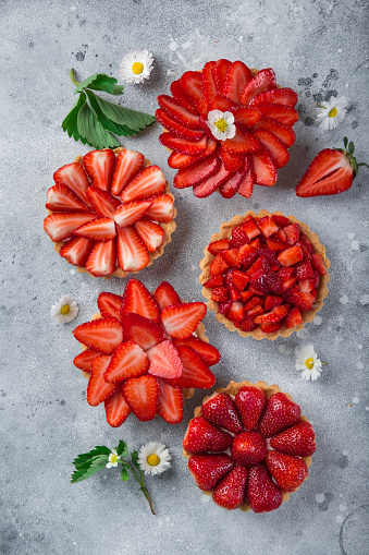 strawberry tarts on gray background, top view, copy space