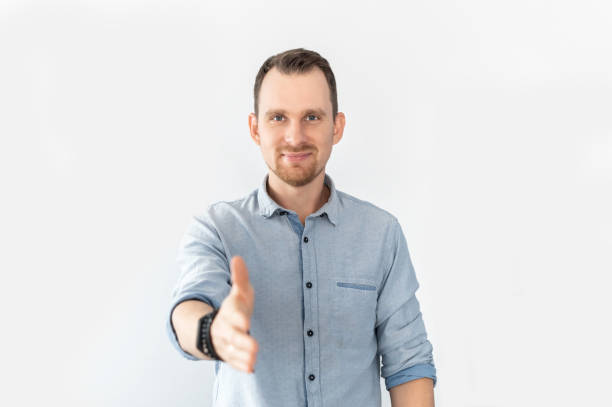 istock A guy holds out his hand in handshake gesture 1314163715