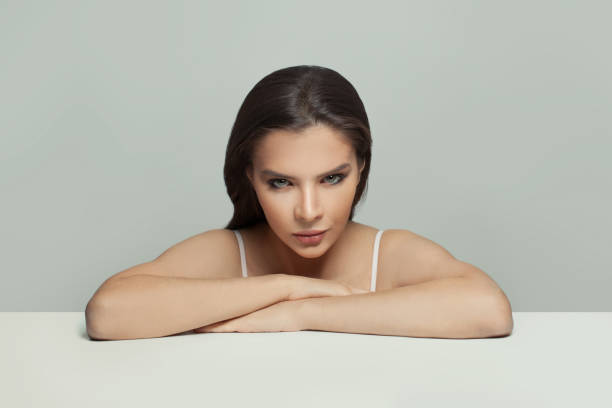 istock Nice woman sitting at white table portrait 1314164788