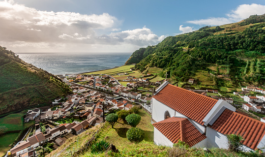 Small village Faial da Terra between rolling hills in warm afternoon light on Sao Miguel Island in the Azores