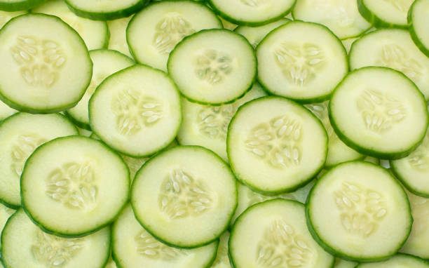 istock background of sliced ​​cucumbers. food background 1314169789