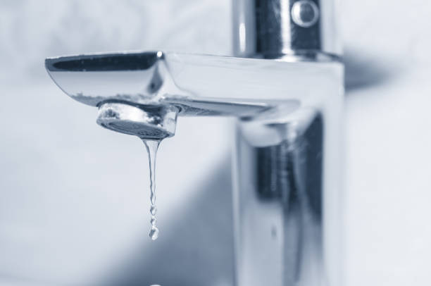 istock Metal faucet with leaking water close up 1314169927
