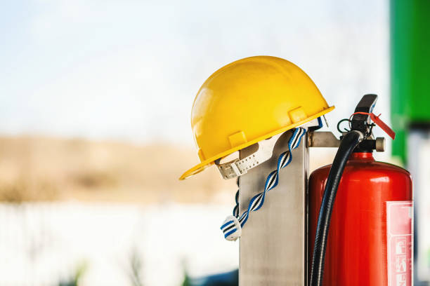 Fire extinguisher and a protective helmet. Fire extinguisher and a protective helmet close up photo. safe security equipment stock pictures, royalty-free photos & images