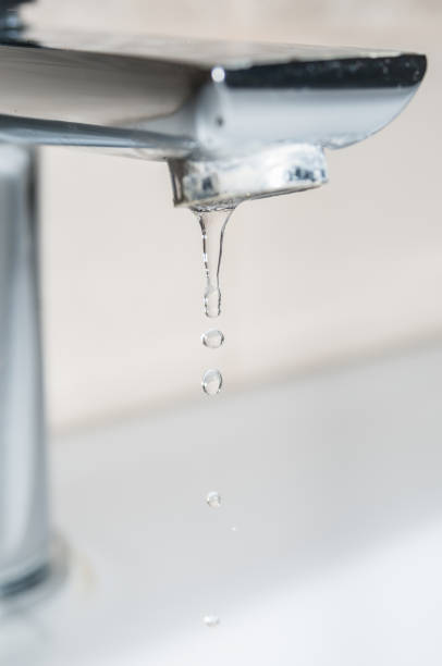 istock Metal tap with dropping water close up 1314172999