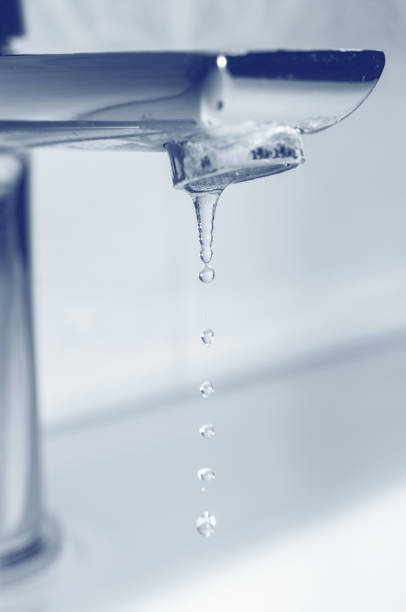 istock Metal tap with leaking water close up 1314173019