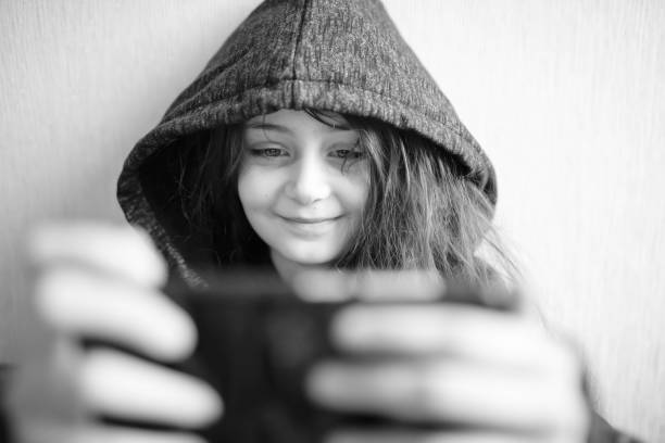 istock Little girl looking at her phone screen 1314173344