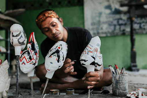 craftsperson  carving wayang golek, one of the traditional Sundanese puppet arts from West Java, Indonesia