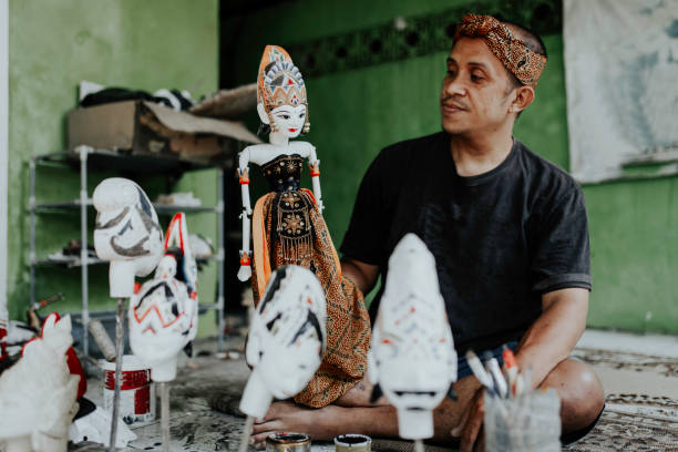 istock sculptress carving wooden figure 1314174170