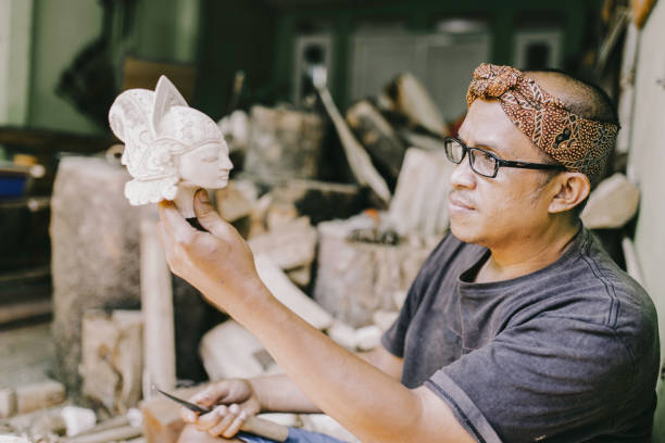 craftsperson  carving wayang golek, one of the traditional Sundanese puppet arts from West Java, Indonesia