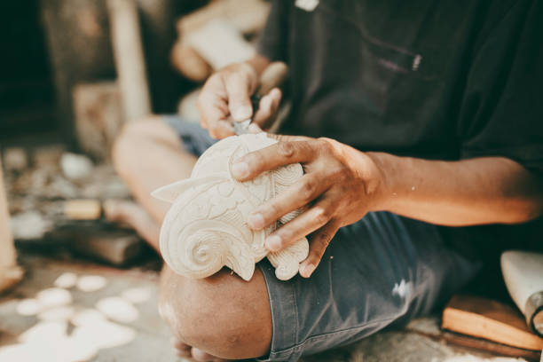 Young man working in his small pottery business