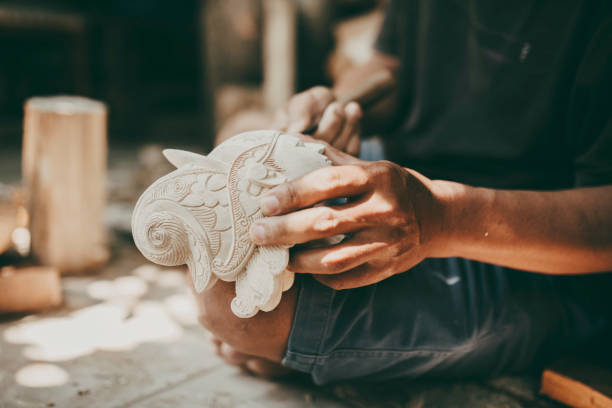 craftsperson  carving wayang golek, one of the traditional Sundanese puppet arts from West Java, Indonesia