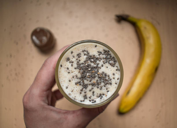 Banana smoothie drink with chia seeds and dulce de leche, on the table, healthy and rich food