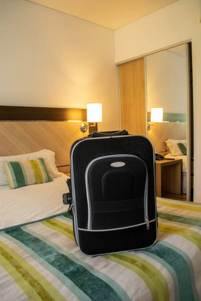 istock travel suitcase on a hotel bed in a luxurious room 1314175465