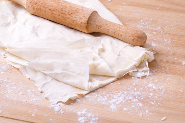 Filo dough and rolling pin Filo dough and rolling pin on the wooden board filo pastry stock pictures, royalty-free photos & images