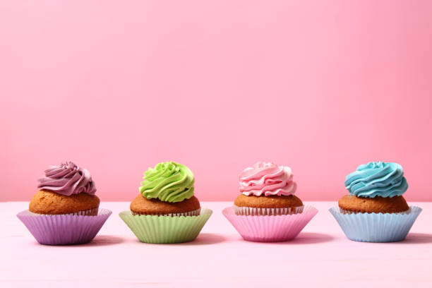 istock Delicious cupcake with a candle on a colored background with space for text. 1314175982