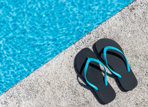 istock Flip flops on the edge of a pool 1314176936