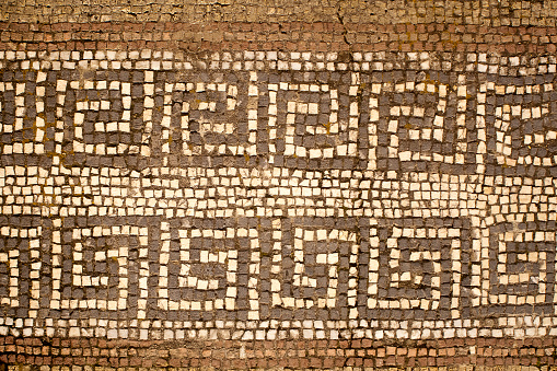 Mosaic flooring, ancient Greek style. Tiled flooring,old, weathered. Image suitable for backgrounds.