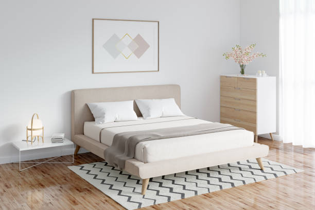istock A bright bedroom with a horizontal poster above the double bed, next to it is a lamp on a coffee table, a vase of flowers on a dresser next to the window, a carpet on the parquet floor. 1314179089