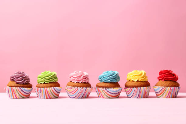 istock Delicious cupcake with a candle on a colored background with space for text. 1314181574