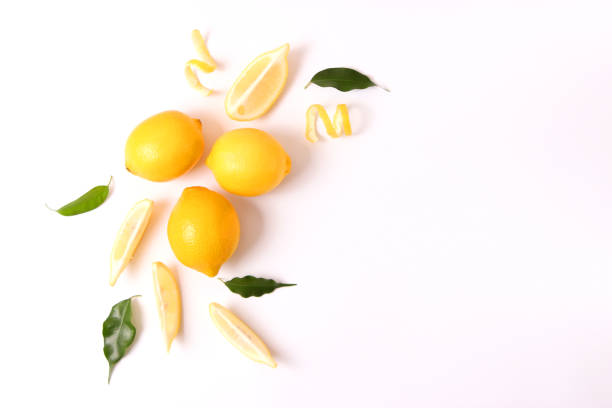 istock lemons and green leaves on a colored background. 1314182167