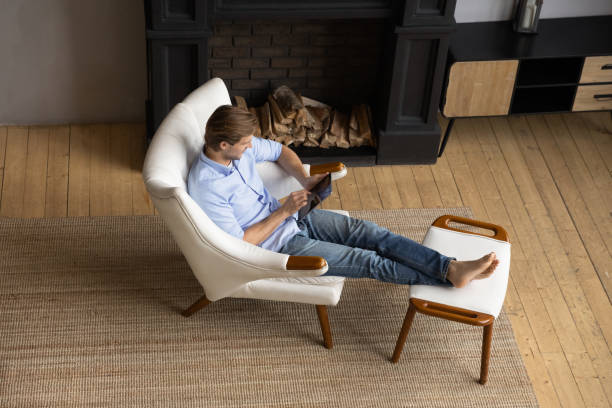 istock Top view young man using tablet, relaxing in cozy armchair 1314187236