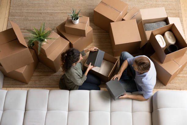 istock Top view happy couple unpacking boxes, moving day, relocation 1314187273