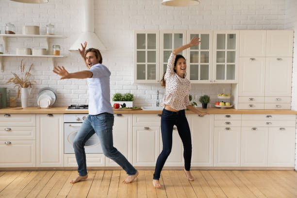 istock Overjoyed young couple dancing in kitchen, having fun together 1314187331