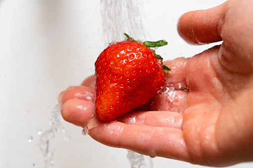 Wash the strawberries with water