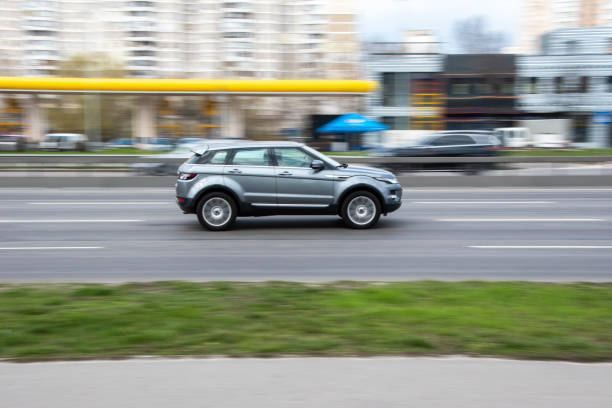 Ukraine, Kyiv - 6 April 2021: Silver Land Rover Range Rover Evoque car moving on the street. Editorial Ukraine, Kyiv - 6 April 2021: Silver Land Rover Range Rover Evoque car moving on the street. Editorial evoque stock pictures, royalty-free photos & images