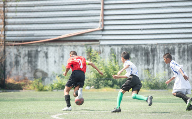istock boy play soccer or football game 1314192349