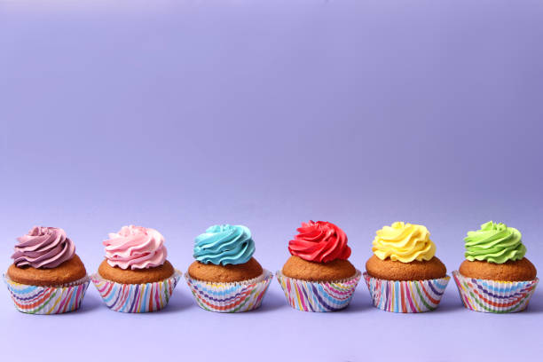 istock Delicious cupcake with a candle on a colored background with space for text. 1314192502