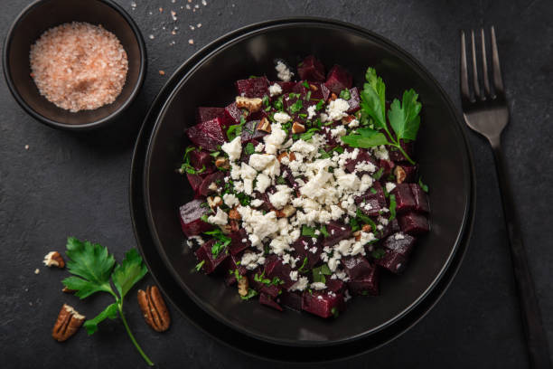 istock beetroot, feta cheese and walnut salad, black background 1314192769