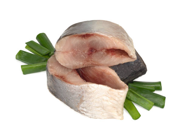 istock Lightly salted Norwegian herring with fresh green onions, isolated on white background. 1314198348