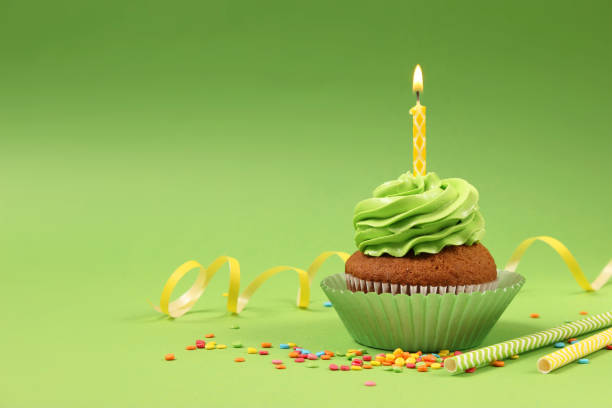 istock Delicious cupcake with a candle on a colored background with space for text. 1314199591