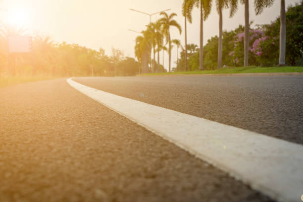 istock Blur background,Morning road with trees by the way and sunlight 1314201741