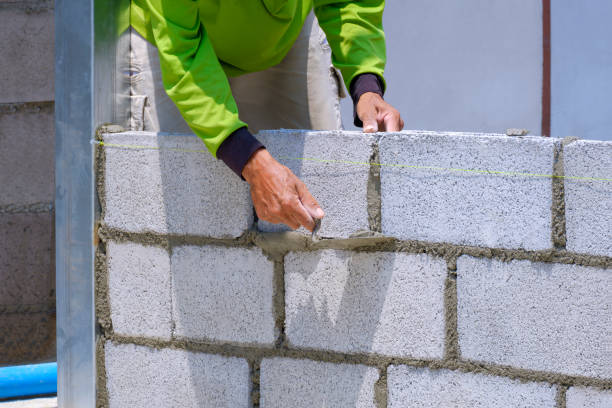 istock Cropped image of Asian builder worker building concrete block wall in house construction site 1314202986