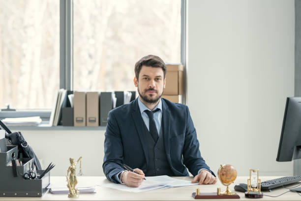 istock Bearded manager in suit sitting at desk 1314203072
