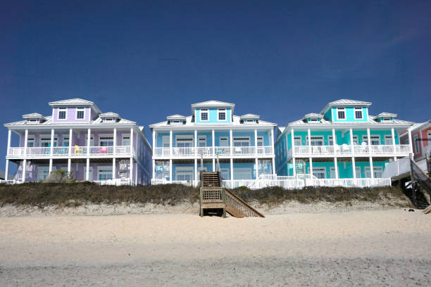 Row of multicolored houses on a sandy beach stock photo