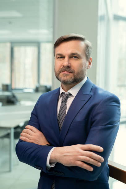 istock Portrait of content bearded manager in dark blue suit 1314203202