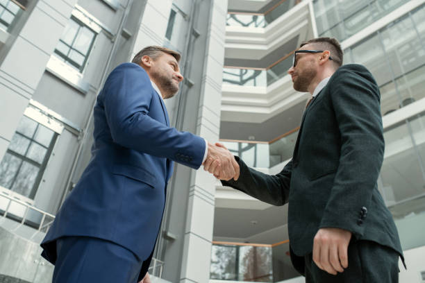 istock Lawyers making handshake in hall 1314203440