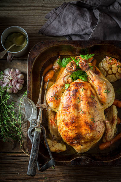 istock Roasted chicken with thyme and carrots. Grilled chicken with herbs. 1314204217