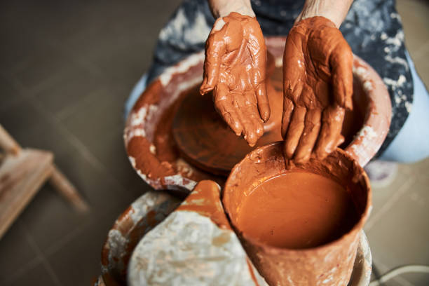 istock Senior woman making clay pot in pottery workshop 1314204410