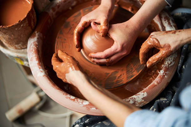 istock Potter hands sculpting clay pot on pottery wheel 1314204418