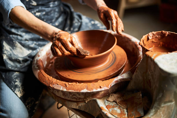 istock Female potter hands making clay pot in pottery workshop 1314204468