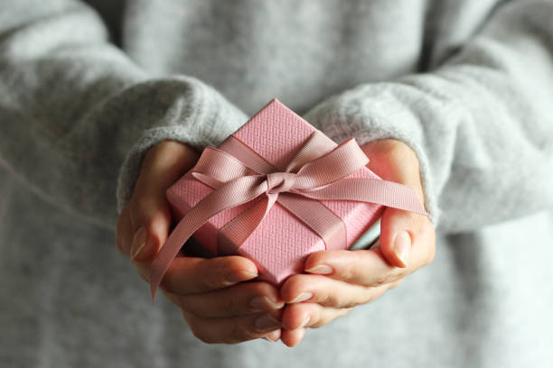 istock gift box in female hands. Holiday, give, gift. 1314205321