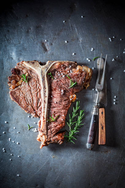 istock Tbone steak with herbs and salt. Well done tbone steak. 1314205356