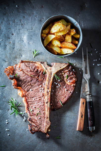 istock Tbone steak and chips. Well done tbone steak with chips. 1314205695