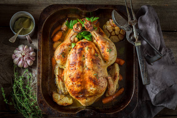 istock Roasted chicken with herbs. Grilled chicken with herbs and vegetables 1314205755