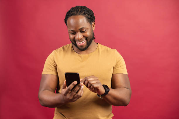 istock African American man holding mobile phone 1314206458