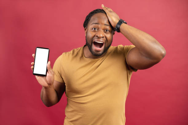istock Amazed African American man showing mobile phone 1314206497